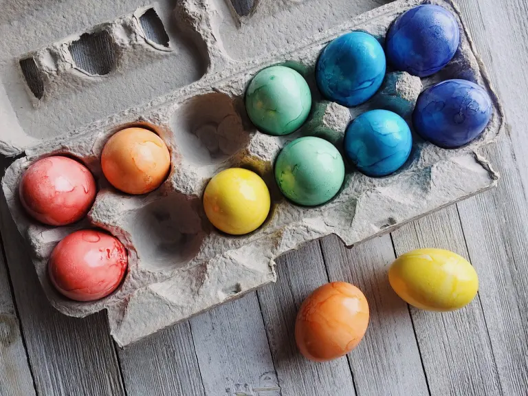 colored eggs in a carton